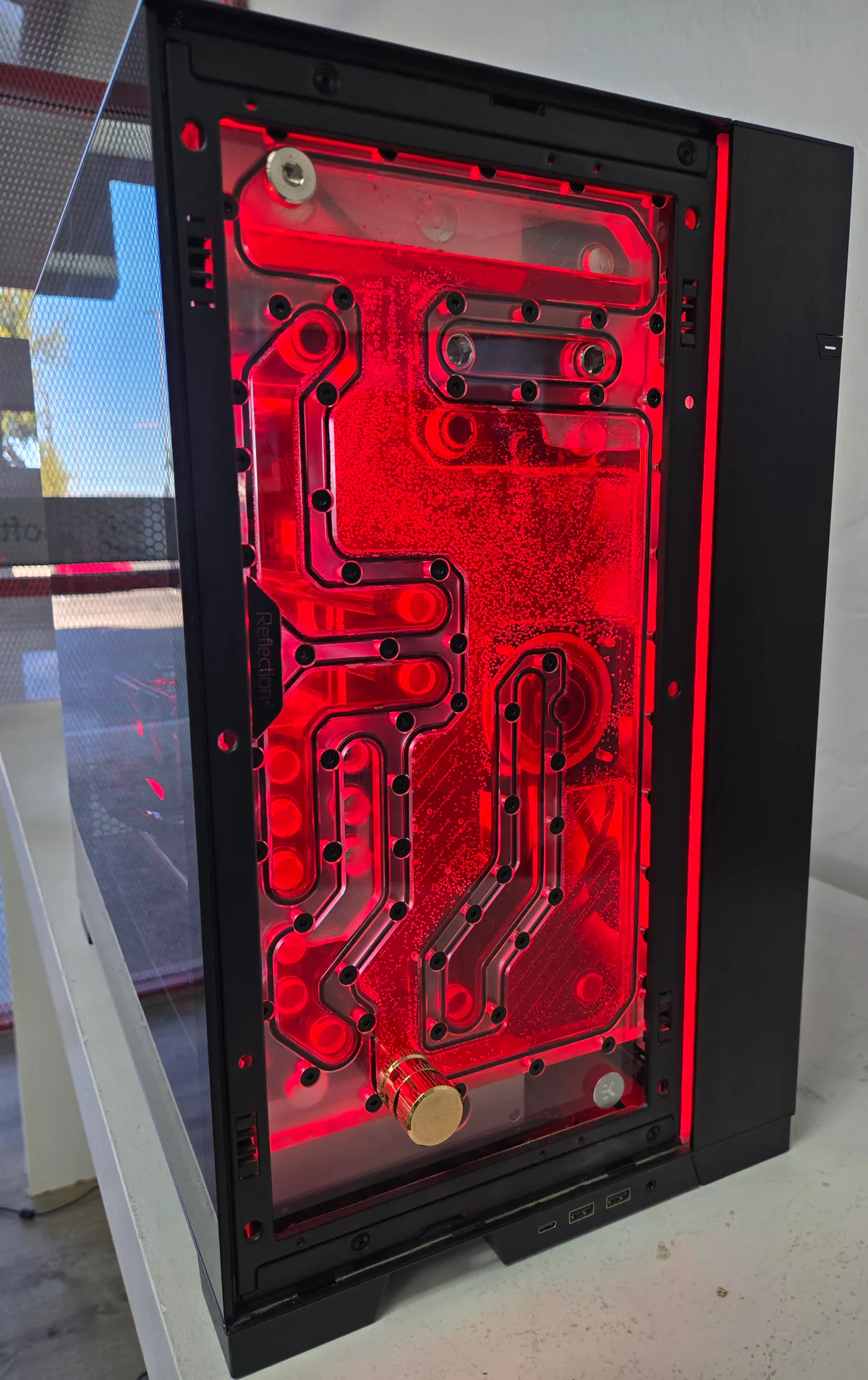 Illuminated red distribution plate for a custom PC water-cooling loop