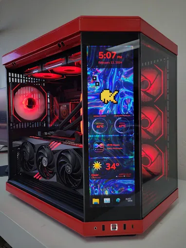 Red HYTE gaming PC with a vertical display and coordinated lighting